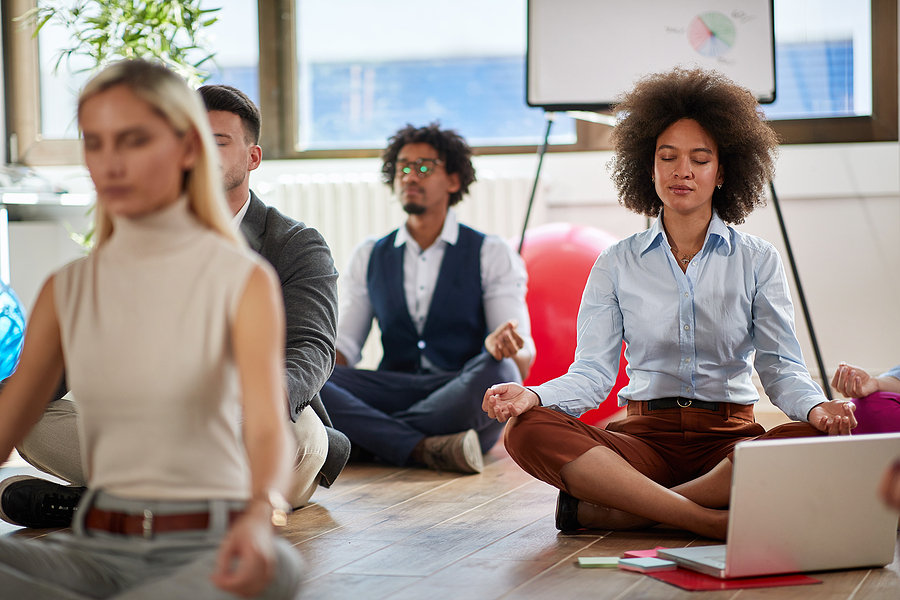 group of business coworkers meditating at work. modern, business, meditation concept